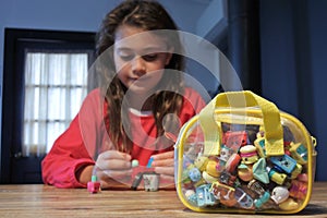 Young girl holding Shopkins a range of tiny collectable toys manufactured by Moose Toys