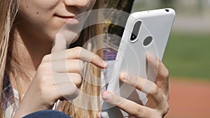 Young Girl Playing Smartphone, Adolescent Kid Browsing Internet on Smart Phone in Park, Teenager Child use Devices Outdoor Nature