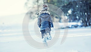 Young girl are playing with snow.Beauty Winter happy Girl Blowing Snow in frosty winter park or outdoors.