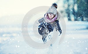 Young girl are playing with snow.Beauty Winter happy Girl Blowing Snow in frosty winter park or outdoors.