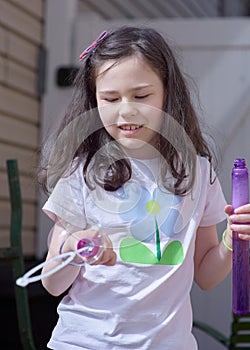 young girl playing with soap bubbles