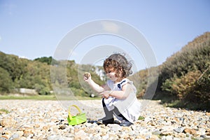 Young girl playing with stones
