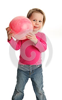 Young girl playing with a toy ball