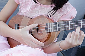 girl playing ukulele