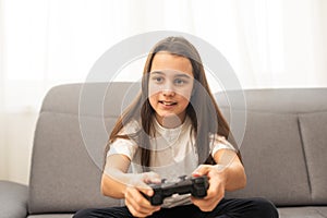 young girl playing video games on white. High quality photo