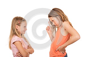 Young girl pointing finger at her sister