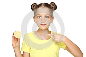 Young girl pointing on lemon fruit