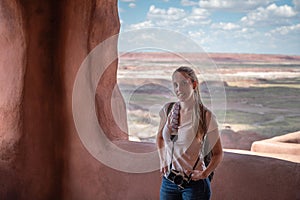 young girl  on the porch of the old indigenous house in Petrified Forest National Park