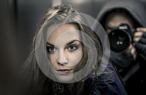 Young girl portrait in elevator mirror with photographer in background