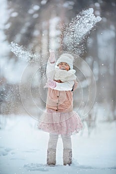 Young girl portrait have fun with snow in winter park