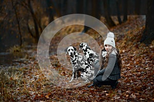 Young girl portrait with her Dalmatian dogs