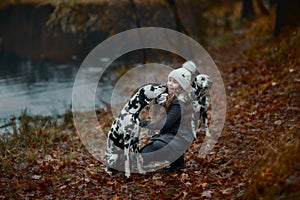 Young girl portrait with her Dalmatian dogs
