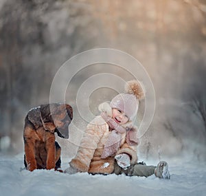 Young girl portrait with puppy under snow