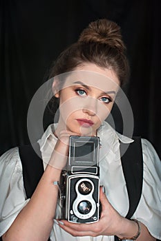 Young girl portrait and retro camera and old fashion style clothing.