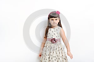 Young girl poses for a picture isolated on white.