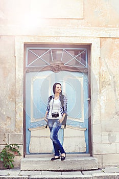 Young girl posing next to a vintage door