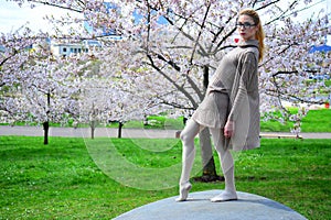 Young girl posing in the sakura garden