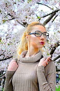 Young girl posing in the sakura garden