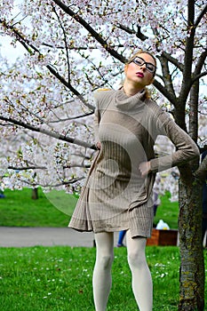 Young girl posing in the sakura garden