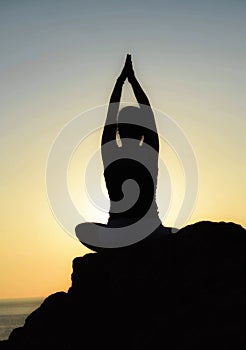 A young girl practices yoga.Sunset yoga.