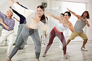 Young girl practicing vigorous dance movements in group class