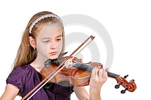 Young girl practicing the violin.