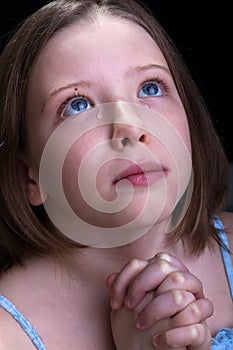 Young girl praying and crying