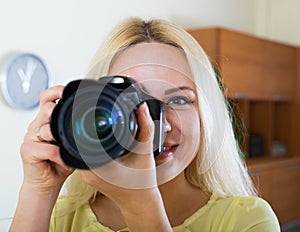 Young girl with professional photocamera