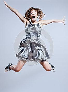 Young girl prom dress jumping screaming happy