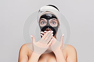 Young girl with purifying black face mask