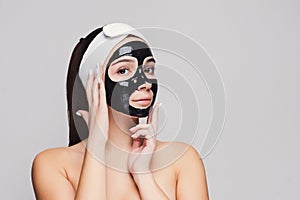 Young girl with purifying black face mask