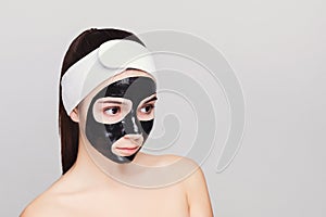 Young girl with purifying black face mask