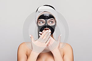 Young girl with purifying black face mask