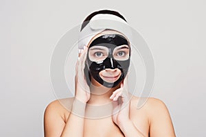 Young girl with purifying black face mask