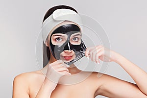 Young girl with purifying black face mask