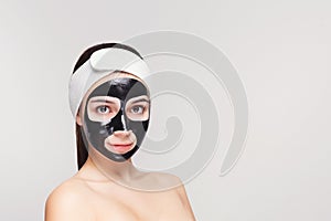 Young girl with purifying black face mask