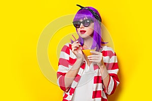 Girl with purple hair holding lemonade cocktail