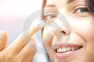 Young girl puts on contact lenses