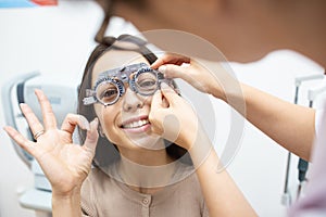 Young girl puts on contact lenses