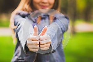 Young girl puts her big thumbs up