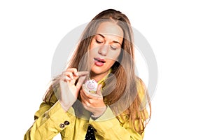 Young girl putting coin in small piggy bank