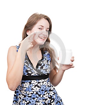 Young girl putting cream