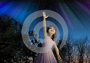 Young Girl Reaching for the Stars in Hope