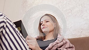 young girl is reading a book. home wear lying in bed. Rest relax good mood lifestyle concept