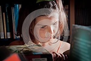 Young girl reading in a library