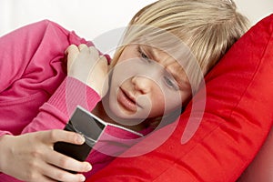 Young Girl Reading Text And Looking Worried