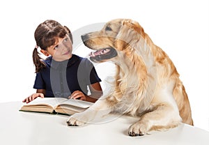 Young girl reading to her dog