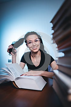 Young girl reading very interesting book at home