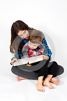 Young Girl Reads Bible To Her Little Brother