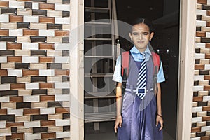 A young girl ready with uniform - small kid leaving home for school - Concept of back to school and starting